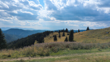 Lush green valley and mountains dominating the landscape under blue sky