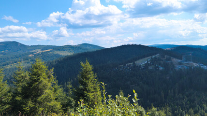 Lush green valley and mountains dominating the landscape under blue sky