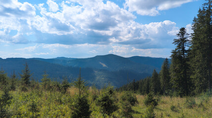 Lush green valley and mountains dominating the landscape under blue sky