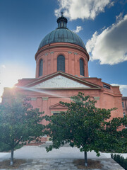 Dome de la Grave in Toulouse, France with blue sky, green trees and clouds in golden hour © Ensapa37