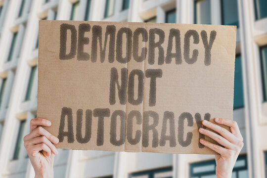 Democracy Not Autocracy" highlighting opposition to authoritarian drift in politics. FREEDOM. RIGHTS. RESISTANCE. LIBERTY. CIVIL. ACTIVISM. JUSTICE.