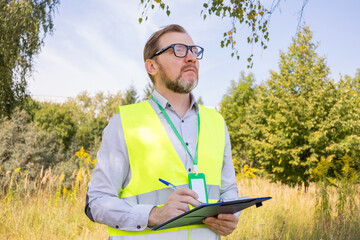 Portrait of a male ecologist in the forest, controls the ecological situation of the environment....