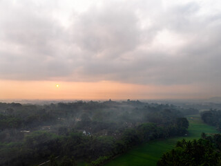 Aerial view of the countryside around Borobudur Temple at sunrise.