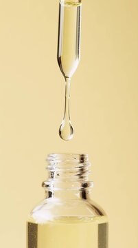 Macro Close-Up of Serum Dropper Above Glass Bottle &ndash; Skincare Concept