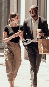 Stylish Man and Woman Walking Outdoors with Coffee Cups &ndash; Urban Lifestyle