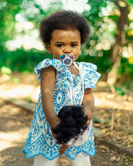 Beautiful black girl, 1 year and 5 months old, playing in nature. Beautiful baby, African baby....