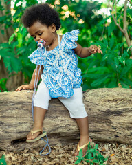 Beautiful black girl, 1 year and 5 months old, playing in nature. Beautiful baby, African baby....
