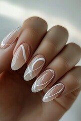 Elegant White Nail Art Design Showcasing Delicate Patterns on Almond-Shaped Tips