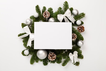 Festive Christmas tree branches with mock up black on color background, top view