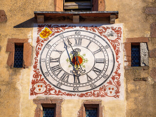 Vintage Clock Face on Historic Building Facade of Ribeauville, Alsace