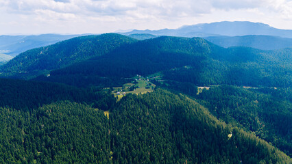 Aerial view of Trebević mountain with its green slopes, forested ridges, and panoramic view of...
