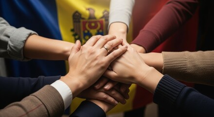people stacks hands together in powerful gesture of unity and teamwork on Moldovan national flag background. symbol of solidarity, national pride, collaboration, collective strength of Moldovan people