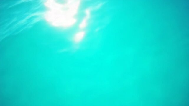 Sea water surface. Aerial view on clear azure sea water. Sun glare. Abstract nautical summer ocean nature. Holiday, vacation and travel concept. Nobody. Slow motion. Weather and climate change