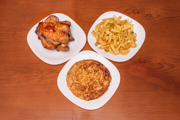 Lemon-roasted chicken with garlic and rosemary, presented with homemade fries cut into sticks and sprinkled with sea salt