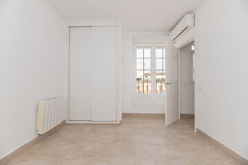 Loft-style bedroom with exposed metal pipe wardrobe and solid wood shelves