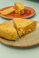 Portion of homemade potato omelet showing its creamy texture, with the potatoes perfectly integrated into the egg batter
