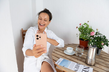 Happy Woman Enjoying Video Call on a Relaxing Patio Setup