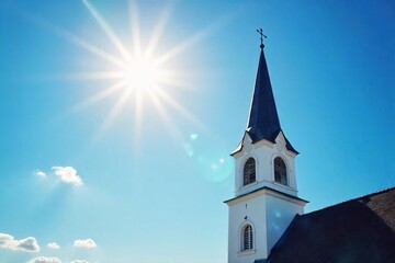 Fototapeta premium Serene church steeple reaching towards a vibrant blue sky, bathed in sunlight Perfect for religious, peaceful, or inspirational themes , vertical, worship
