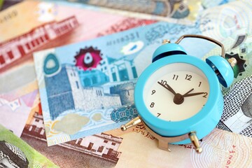 Bahraini dinar currency money bills and alarm clock. The concept of time management and income