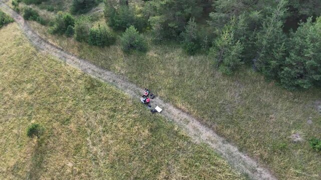 Aerial view of family having a break on a meadow during  hike.