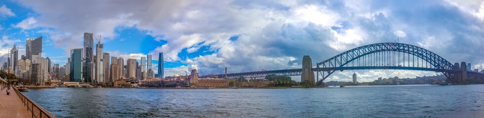Naklejka premium Panoramic view of the Sydney Circular Quay waterfront, the harbor and harbor bridge, New South Wales, Australia