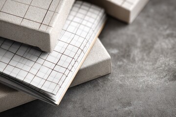 Stack of light beige boxes and notebooks