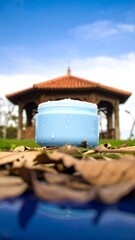 Light blue jar on autumn leaves in a gazebo