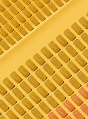 Seamless diagonal rows of golden jelly candies on warm yellow background
