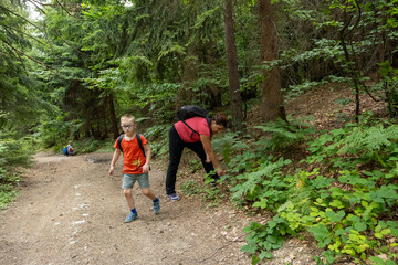 Family hike in the forest. Happy family moments in nature, hiking trip with kids and enjoying fresh air in the forest.