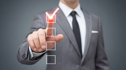 Businessman In Formal Suit Pressing Virtual Checklist With Red Check Mark Symbol Representing Task Completion Success