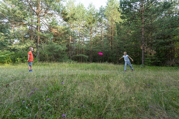 Family with child with disability spending quality time outdoors, hiking in lush green woodland....