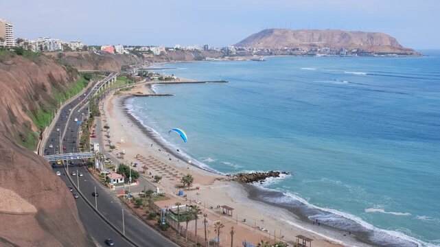 Paragliding over miraflores district, lima, peru, with the morro solar in the background