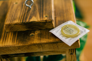condom in a package in the interior of a living room in a residential building. concept: unwanted...