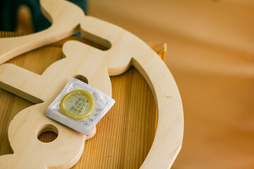 condom in a package in the interior of a living room in a residential building. concept: unwanted...
