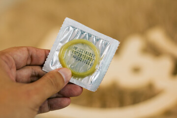 condom in a package in the interior of a living room in a residential building. concept: unwanted...