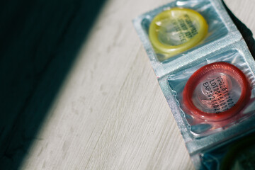 condom in a package in the interior of a living room in a residential building. concept: unwanted...