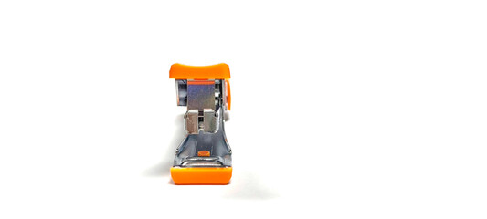 Fototapeta premium Orange stapler on white background