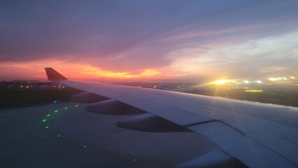 Morning sunrise in Vietnam over the wing of a plane. 