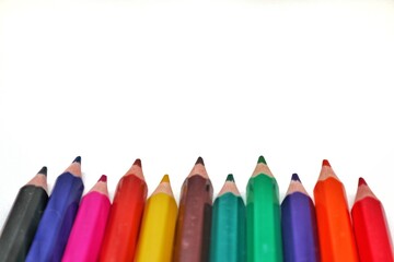 A detailed close-up shot of the sharpened tips of several colorful pencils, highlighting their...