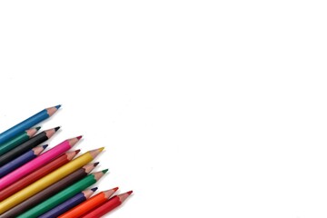 A vibrant collection of colorful pencils arranged from the bottom left side at a 45-degree angle, showcasing their tips and diverse colors, perfect for creative or educational themes.