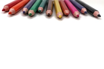 A detailed, top-down perspective capturing the vibrant, sharpened tips of an array of colorful...