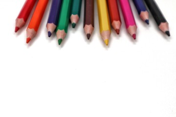 A brightly colored collection of pencils neatly arranged at the top of the frame, presented from a direct overhead view. This image is perfect for themes of creativity, education, or art supplies.