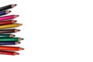 An assortment of colorful pencils aligned along the left edge of the frame, leaving ample space on the right for text or other graphic elements.