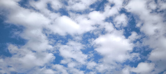 Sky is blue and clear with no clouds. The sky is very bright and the sun is shining. Blue sky with scattered white clouds creating a serene and peaceful atmosphere.