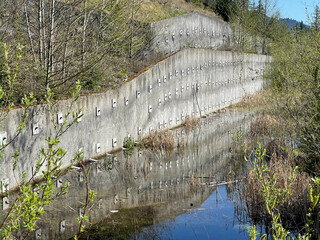A retaining wall and stormwater retention pond in the city