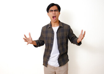 Serious Asian man standing and looking at the camera with an angry expression, isolated on a white...