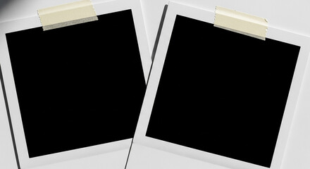Two blank instant photos attached with tape on white background