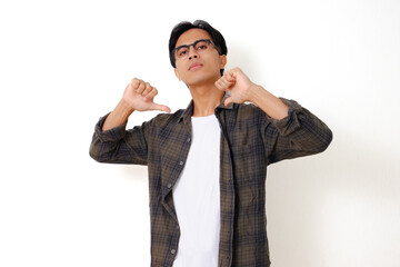 Confident young Asian man standing and pointing to himself with an arrogant expression, isolated on white background