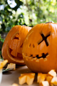 Halloween time, Carved pumpkins with spooky faces on display on deck during autumn festivities