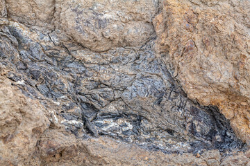 Greenstone / Metamorphic rock. Weathered. Dark-green to red, altered basaltic volcanic rocks. altered to clay minerals.Coyote Point Beach, San Mateo, California. San Francisco Peninsula / Bay